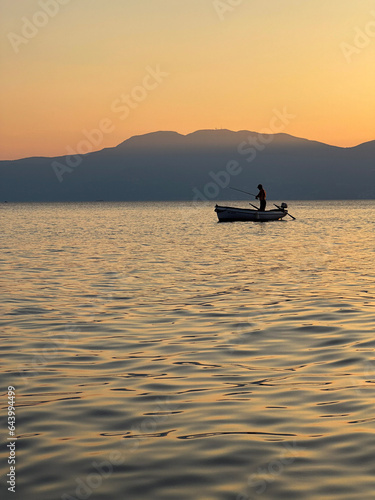 silhouette of a person in a boat