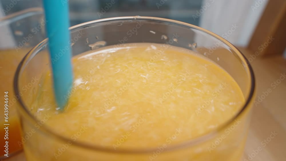 I stir the pulp in the glass of orange juice with a straw and take a sip, close-up, in slow motion. I stir the pulp in the glass of orange juice with a straw and take a sip, close-up, in slow motion.