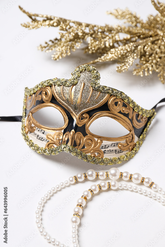 Carnival mask and beads on white background Carnival mask and beads on white background