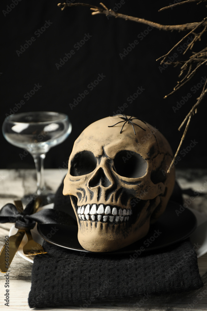 Halloween table setting, skull in a black bowl Halloween table setting, skull in a black bowl