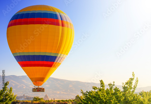 Cappadocia yellow hot air balloon at sunrise