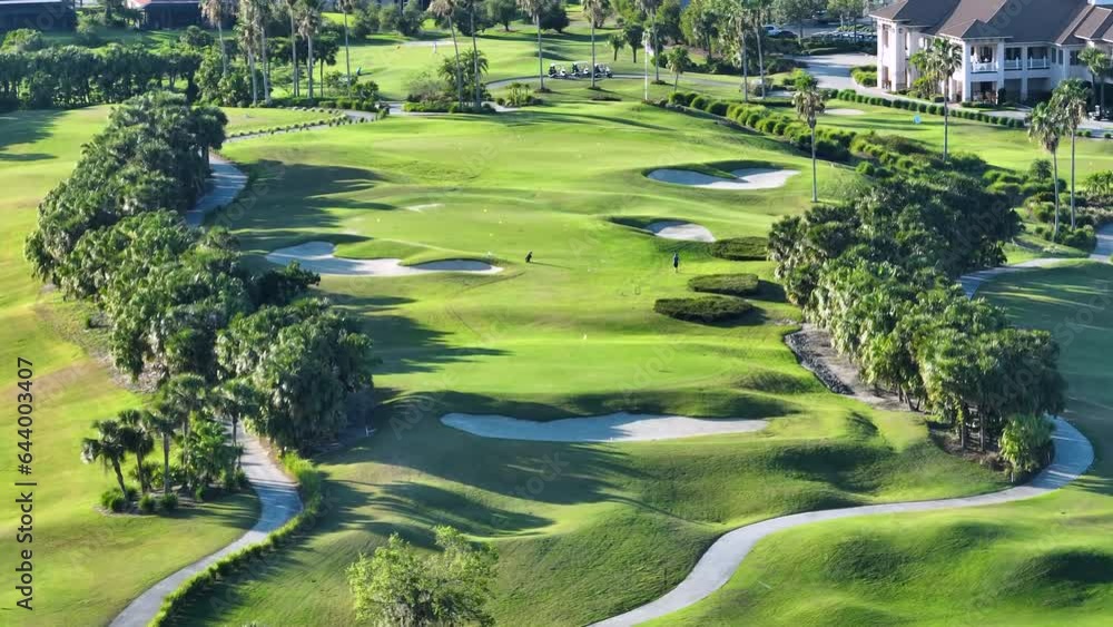 Professional golf player practicing on golf course in sunny Florida. Outdoor activities of rich people Professional golf player practicing on golf course in sunny Florida. Outdoor activities of rich people