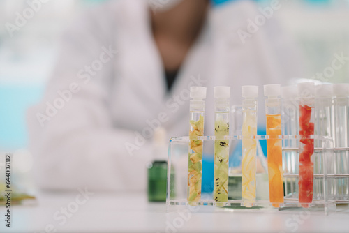 Cosmetic laboratory research and development , lab glassware containing fresh fruits.