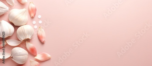 Garlic supplements pictured against isolated pastel background Copy space
