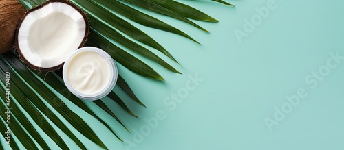 Coconut themed cosmetics for skin care hair care and hydration displayed on a isolated pastel background Copy space in a top down view