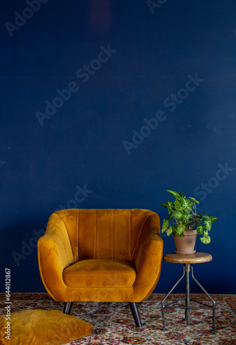 Interior element, yellow empty armchair against blue wall background, copy space
