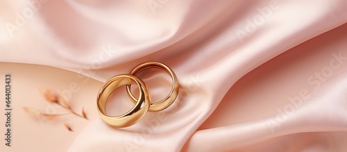 Gold jewelry including a ring and earrings showcased against a isolated pastel background Copy space