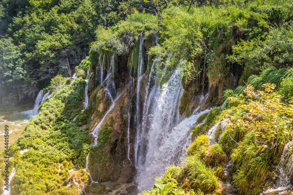 Top view of the beautiful picturesque waterfalls on Plitvice Lakes. Rocks and green trees around lakes with blue water. Breathtaking view in the Plitvice Lakes National Park .Croatia Top view of the beautiful picturesque waterfalls on Plitvice Lakes. Rocks and green trees around lakes with blue water. Breathtaking view in the Plitvice Lakes National Park .Croatia