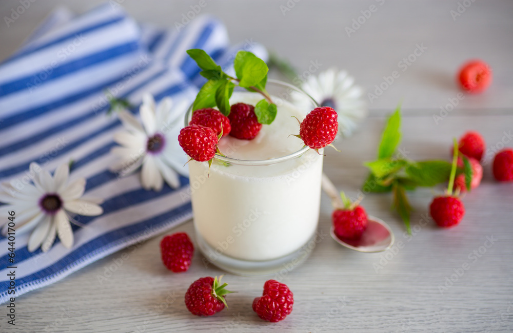 Sweet cooked homemade yogurt with fresh raspberries in a glass. Sweet cooked homemade yogurt with fresh raspberries in a glass.