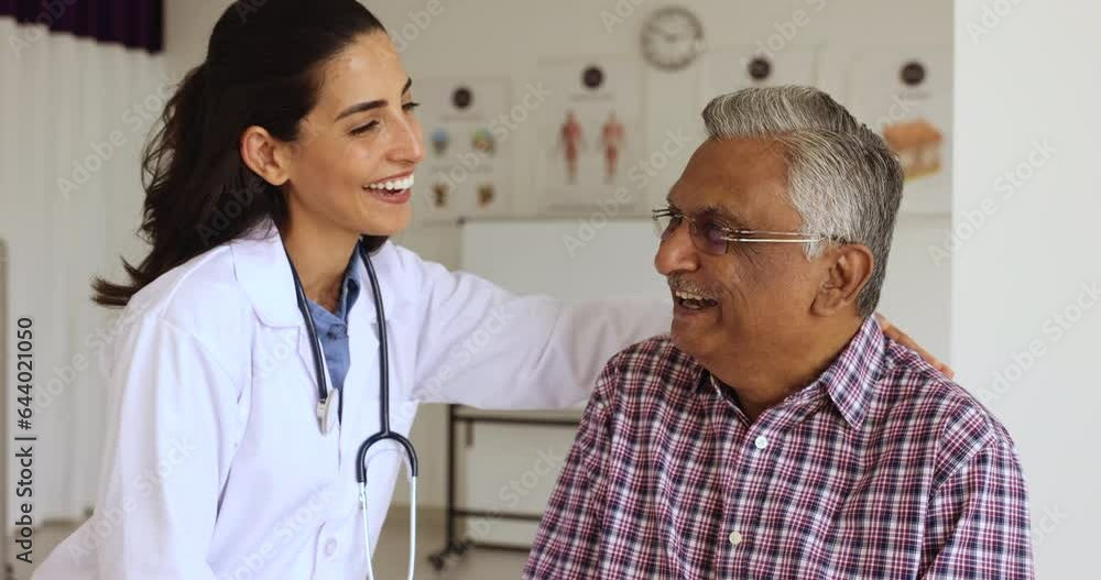 Smiling female therapist, medical worker hug happy older patient, encouraging, giving hope share optimistic news about recovery, enjoy pleasant conversation at visit in clinic. Eldercare, gerontology Smiling female therapist, medical worker hug happy older patient, encouraging, giving hope share optimistic news about recovery, enjoy pleasant conversation at visit in clinic. Eldercare, gerontology