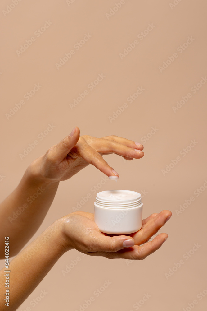 Vertical of hands of asian woman using jar of beauty cream with copy space Vertical of hands of asian woman using jar of beauty cream with copy space