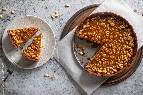 Homemade caramel-peanut cheesecake on a light background. Morning delicious bakery cake