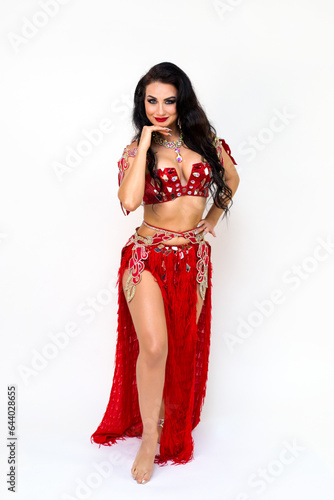 Portrait of beautiful brunette girl from the Academy of Oriental Dance in a traditional costume, stock photo.