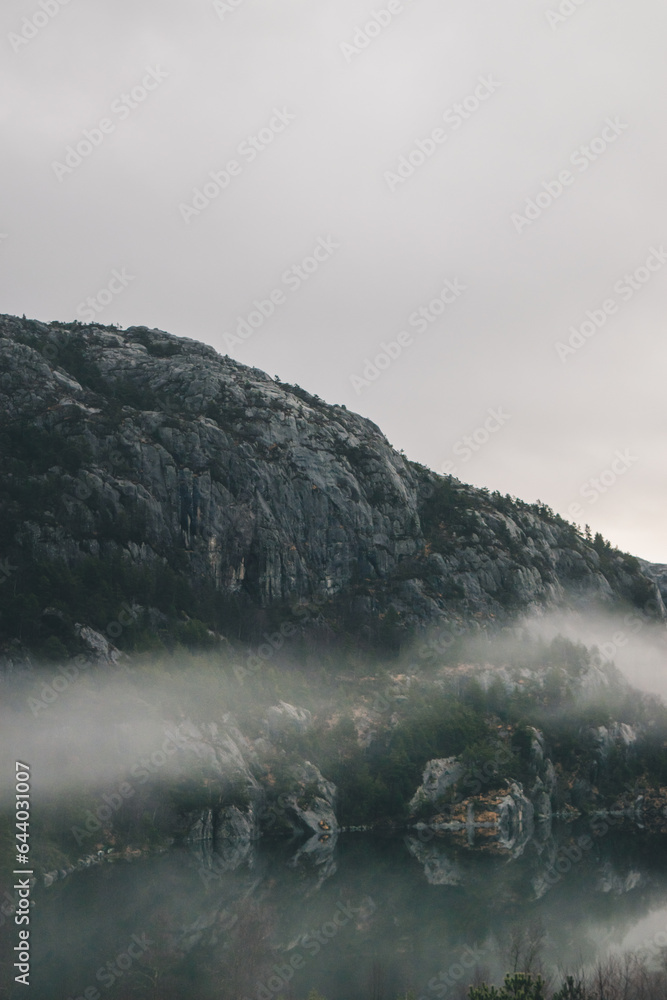 Mountains in Norway. Lake, beach and mountains near Preikestolen. With fog a fairytale picture. Mountains in Norway. Lake, beach and mountains near Preikestolen. With fog a fairytale picture.