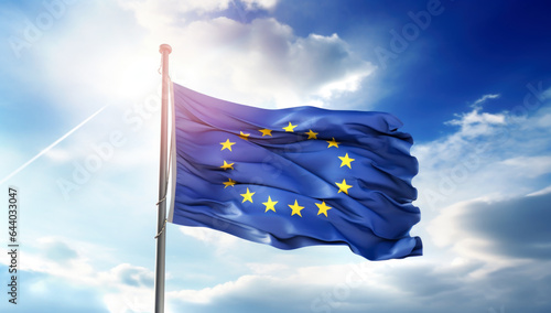 Flag of the European Union waving in the wind on flagpole against the sky with clouds on sunny day, close-up. Made with AI gereration