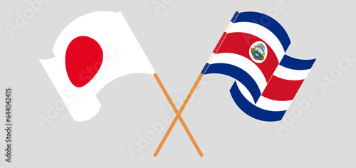 Crossed and waving flags of Japan and Costa Rica