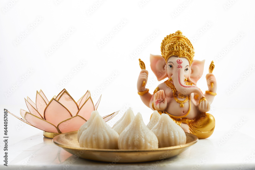 Idol of lord Ganesha with Modak Sweet Dish and flower. Ganesh chaturthi Idol of lord Ganesha with Modak Sweet Dish and flower. Ganesh chaturthi