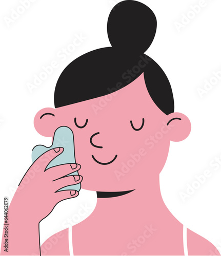 Young woman massaging her face with gua sha stone