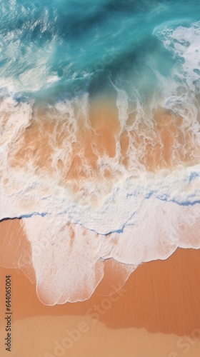An aerial view of a beach with a wave coming in