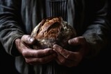 cropped shot of a man holding freshly baked bread in his hands