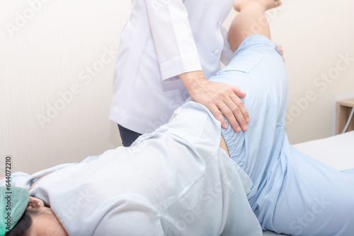 Close up of  physiotherapist is helping woman stretching his hamstring. Professional calf and leg massage by massage therapist.