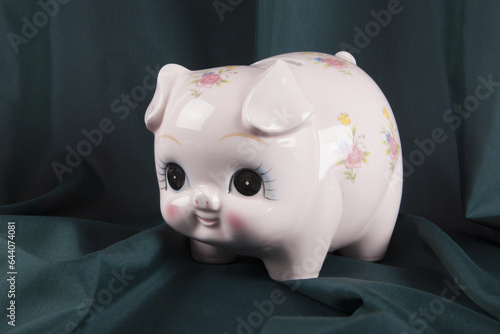 a vintage piggy bank in pink with flower designs