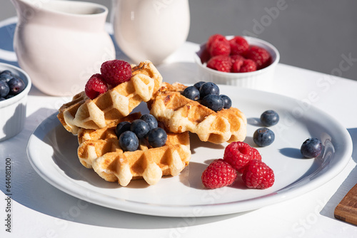 Served breakfast on the street, waffles with berries on a white