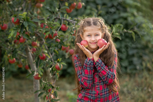 little girl with apples in her hands