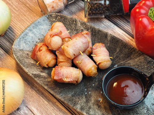 Delicious bacon wrapped sausage with dipping sauce
