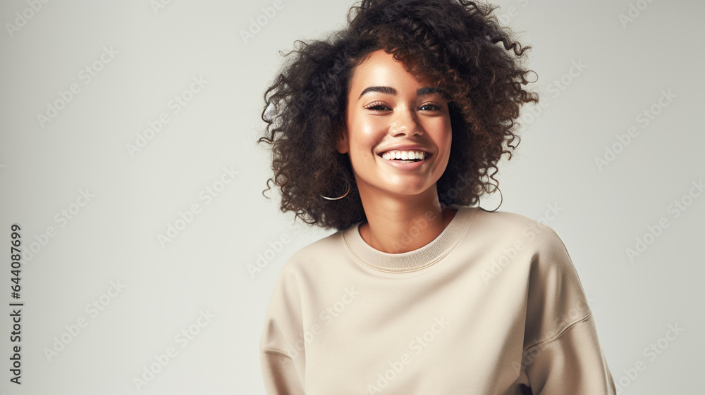 Fototapeta premium Beautiful african american girl with an afro hairstyle smiling. Smiling beautiful afro girl. Curly black hair. Emotion concept.