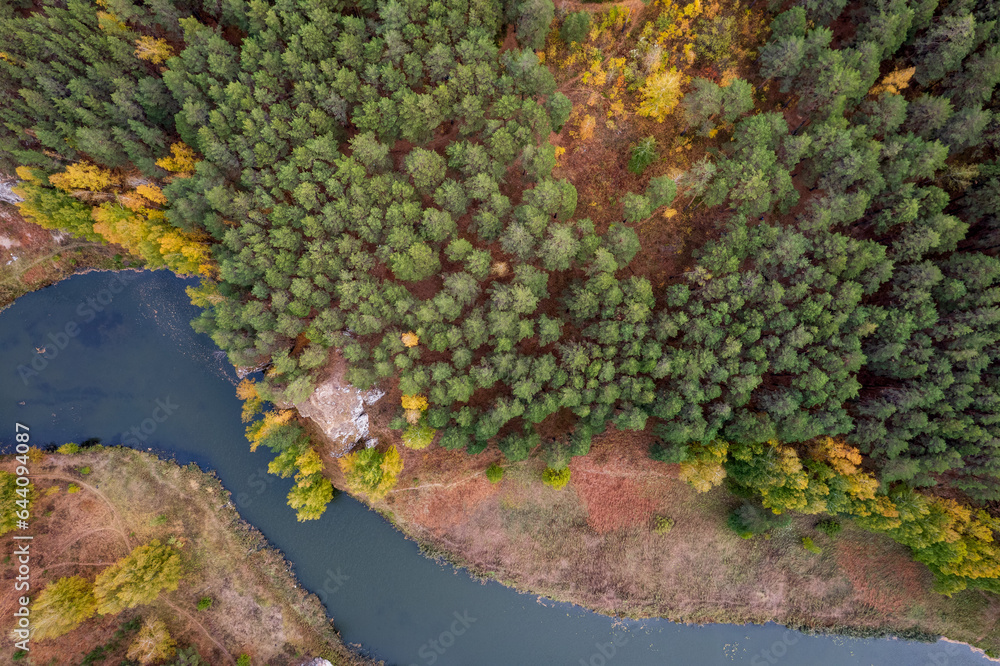 view of the river from above, along the banks of the river autumn forest and shrubs