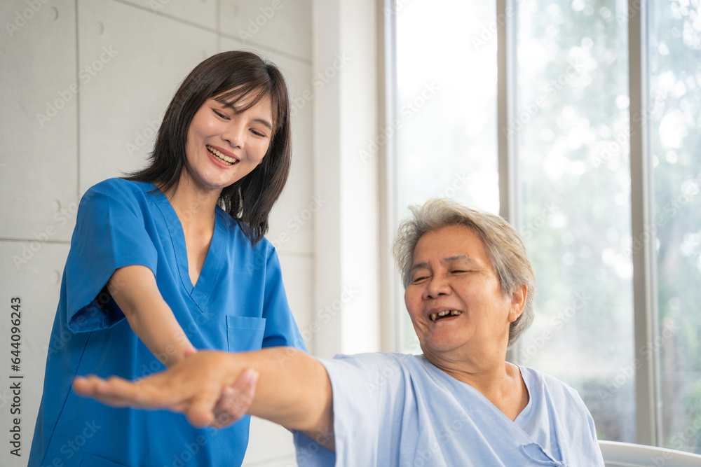 Fototapeta premium Beautiful asian nurse taking care of senior woman to exercise at hospital. She feeling happy when take care senior woman. Healthcare, Retirement, Volunteer, Caregiver and Lifestyle concept.