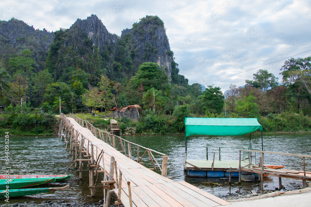 Naklejka premium Rural scenery with Nam Song river bridge in Vang Vieng, Laos