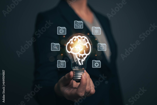  Woman holding light bulb. Online education concept. Finding ideas for work Planning student learning with a self-learning system via online channels