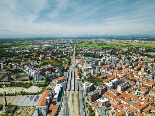 Aerial view of a railway and road intersection in Saronno residential area, a small town in Lombardy region, Varese, Italy.