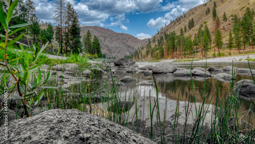 Wide angle long exposure view of little Salmon river on rocky beach with mountain views in Riggins Idaho photo