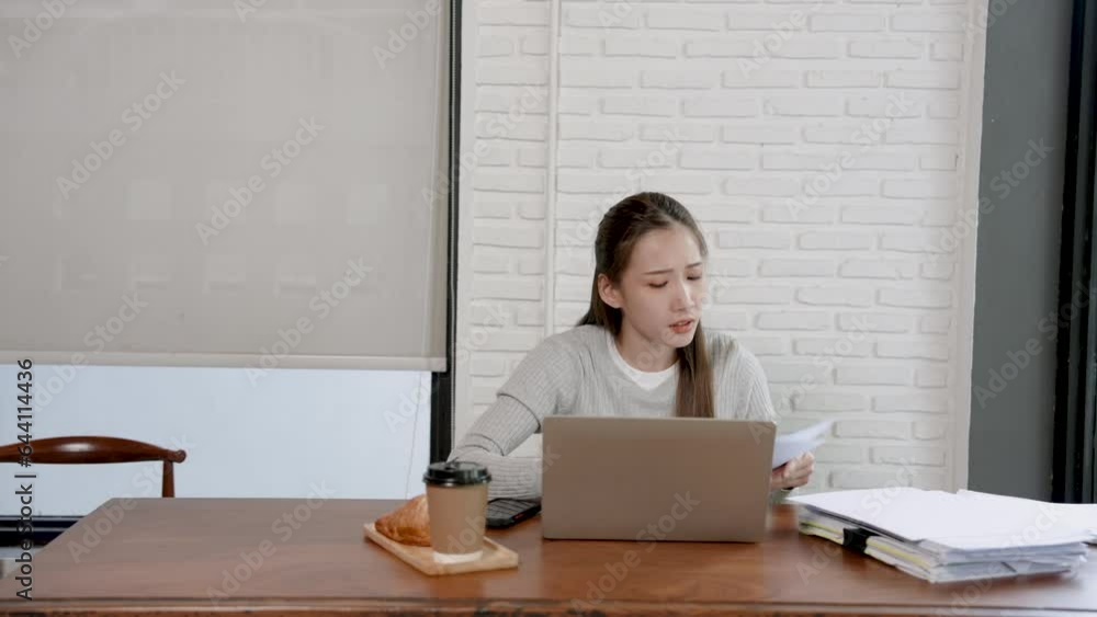 Beautiful young Asian woman sitting at table in cafe After all the stress of checking your store account with your laptop computer. Drink coffee in the afternoon to keep yourself from feeling sleepy. Beautiful young Asian woman sitting at table in cafe After all the stress of checking your store account with your laptop computer. Drink coffee in the afternoon to keep yourself from feeling sleepy.