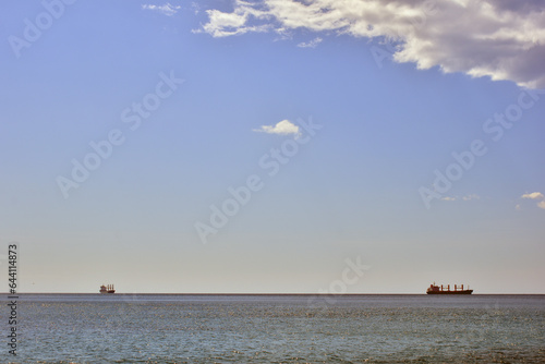 Two ships on open sea on a sunny day. Background panorama of sea, ocean nature beauty. 