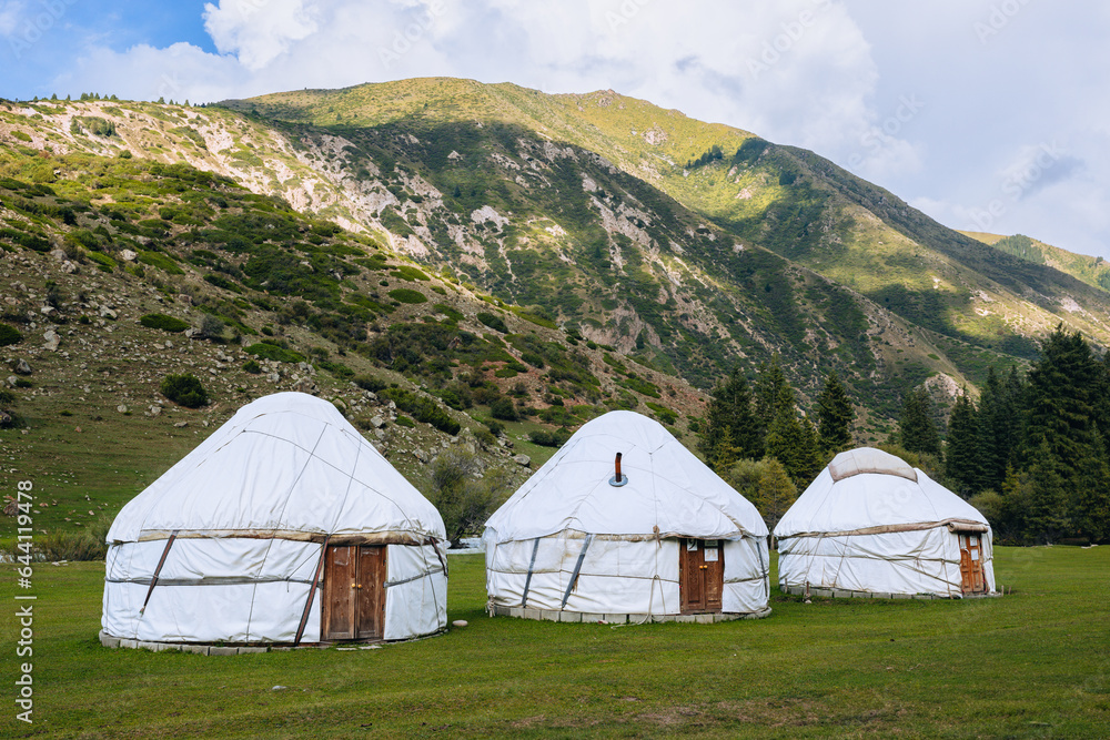 Yurt in Jeti Oguz Valley. National old house of the people of Kyrgyzstan and Asian countries. Yurts on the background of green meadows and highlands. Yurt camp for tourists.