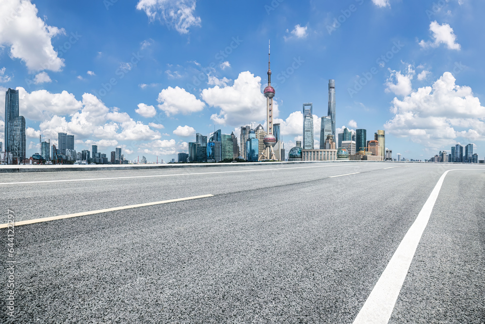Empty asphalt road and city buildings skyline in Shanghai, China