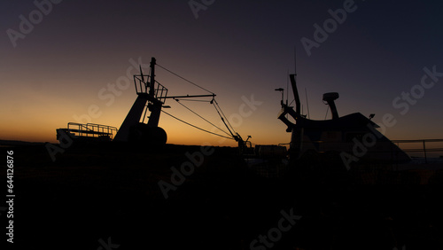 Profile of a fishing ship with beautiful light in purple and yellow