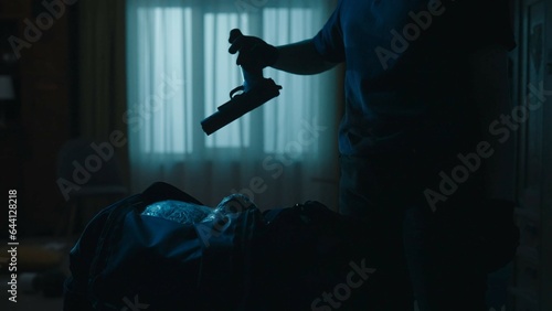 Closeup shot of black sport bag, police officer takes out the handgun. Crime scene creative concept. © kinomaster