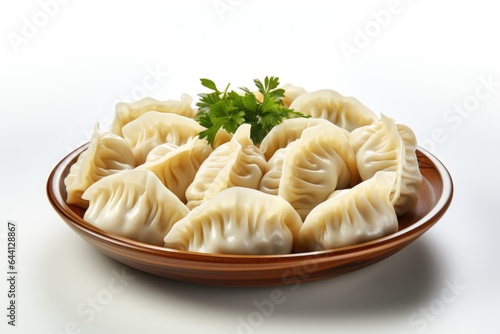 A plate of dumplings with a sprig of parsley. Digital image.