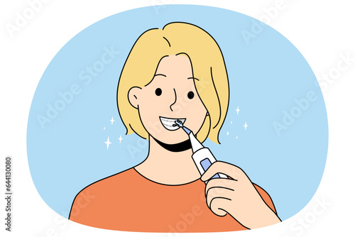 Smiling woman with braces clean teeth with dental irrigator. Happy female use brush take acre of oral hygiene. Dentistry and healthcare. Vector illustration.