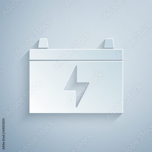 Paper cut Car battery icon isolated on grey background. Accumulator battery energy power and electricity accumulator battery. Paper art style. Vector