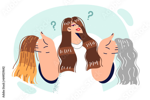 Woman hairdresser offers to dye hair, holding wigs of different colors, for concept changing image