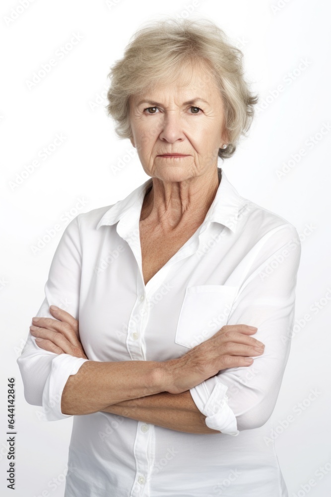 portrait of a mature woman standing with her arms crossed against a white background portrait of a mature woman standing with her arms crossed against a white background