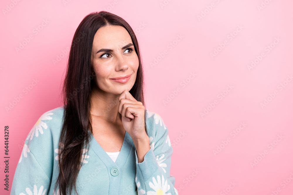 Photo of adorable lovely woman with straight hairdo dressed blue cardigan look empty space arm on chin isolated on pink color background Photo of adorable lovely woman with straight hairdo dressed blue cardigan look empty space arm on chin isolated on pink color background