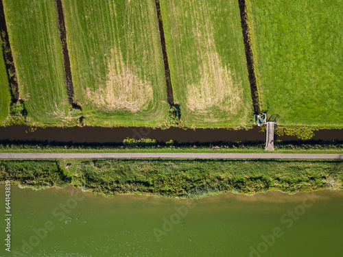 Photos aerial shot of water at the surfplas manmade lake in Reeuwijkse plassen has turned green from algae bloom in summer