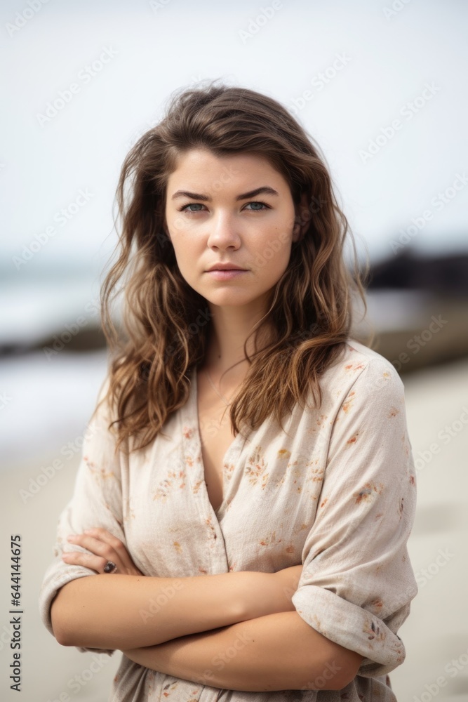 cropped shot of a beautiful young woman standing with her arms folded on the beach cropped shot of a beautiful young woman standing with her arms folded on the beach